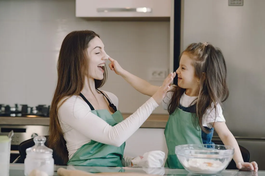 A support worker and a young person cooking together