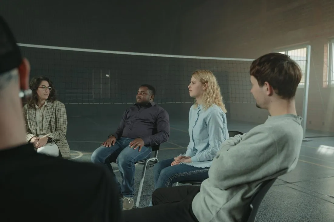 A support worker listening in a group